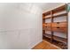 Walk-in closet with built-in wooden drawers and shelving for optimal organization at 1801 Briarcrest Nw Dr, Charlotte, NC 28269