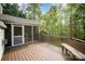 Outdoor deck area with a screened-in porch, wooden railing, and bench seating at 1801 Briarcrest Nw Dr, Charlotte, NC 28269