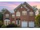 Lovely two-story brick home featuring manicured landscaping, attached two car garage and classic shutters at 1801 Briarcrest Nw Dr, Charlotte, NC 28269