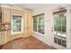 Traditional kitchen with stone tile flooring and wooden cabinets adjacent to glass panel exterior door and window at 1801 Briarcrest Nw Dr, Charlotte, NC 28269