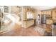 Traditional kitchen featuring tile floors, granite countertops, stainless appliances, wooden cabinets, and views into living room at 1801 Briarcrest Nw Dr, Charlotte, NC 28269