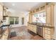 Traditional kitchen features stone tile floors, bright lighting, granite countertops, stainless appliances, and wooden cabinets at 1801 Briarcrest Nw Dr, Charlotte, NC 28269