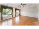 Bright living room featuring bamboo floors and large windows with decorative curtains at 1801 Briarcrest Nw Dr, Charlotte, NC 28269