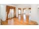 Open-concept living room with large windows, elegant curtains, and hardwood floors at 1801 Briarcrest Nw Dr, Charlotte, NC 28269