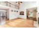 Open concept living room with hardwood floors that flows into the kitchen, a fireplace and a staircase at 1801 Briarcrest Nw Dr, Charlotte, NC 28269