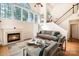 Cozy living room featuring a fireplace, large windows, and comfortable seating for relaxing and enjoying the ambiance at 1801 Briarcrest Nw Dr, Charlotte, NC 28269