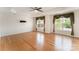 Primary bedroom featuring bamboo floors, a ceiling fan, and large windows with decorative curtains at 1801 Briarcrest Nw Dr, Charlotte, NC 28269