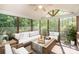Relaxing sunroom filled with natural light, comfortable seating, and tranquil views at 1801 Briarcrest Nw Dr, Charlotte, NC 28269