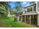 Spacious backyard with screened porch, lush lawn, chimney, and grill, perfect for outdoor gatherings at 181 Riverview Ter, Clover, SC 29710