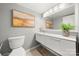 Modern bathroom with floating vanity, framed art, decorative mirror and wood-look tile at 181 Riverview Ter, Clover, SC 29710