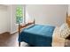Bright bedroom with hardwood floors, featuring a bed with a blue comforter and large window views at 181 Riverview Ter, Clover, SC 29710
