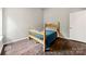 Bedroom with hardwood floors, light walls, and an ornate wooden bed frame with blue comforter at 181 Riverview Ter, Clover, SC 29710