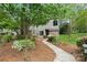 Charming townhome featuring a quaint walkway, colorful landscaping and a lush green tree at 181 Riverview Ter, Clover, SC 29710