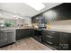 Modern kitchen featuring stainless steel appliances, dark wood cabinets, and a light, bright skylight at 181 Riverview Ter, Clover, SC 29710