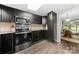 Modern kitchen featuring stainless steel appliances, dark cabinets and view of eat-in dining space at 181 Riverview Ter, Clover, SC 29710