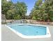 Community swimming pool featuring a shallow end, deck area, and mature trees, for refreshing leisure at 181 Riverview Ter, Clover, SC 29710