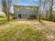 Large backyard with a firepit, patio, and mature trees, perfect for outdoor enjoyment at 1907 Caprington Dr, Fort Mill, SC 29707