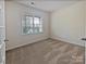 Cozy bedroom featuring carpeted floors and a window providing natural light at 1907 Caprington Dr, Fort Mill, SC 29707