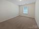 A carpeted bedroom with a window offering natural light and ventilation at 1907 Caprington Dr, Fort Mill, SC 29707