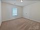 Well-lit bedroom with neutral walls and carpet, a double door closet, and a window, great for relaxation at 1907 Caprington Dr, Fort Mill, SC 29707