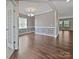 Bright dining room with wainscoting, hardwood floors, and a modern chandelier at 1907 Caprington Dr, Fort Mill, SC 29707
