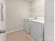 Functional laundry room with tile floors, washer, dryer, and shelving at 1907 Caprington Dr, Fort Mill, SC 29707