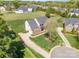 Expansive aerial view of a brick home highlighting its manicured lawn and neighborhood at 2003 Ptarmigan Ct, Waxhaw, NC 28173