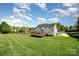 Expansive green backyard with a wooden deck, perfect for outdoor enjoyment at 2003 Ptarmigan Ct, Waxhaw, NC 28173