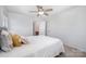 Bright bedroom with a ceiling fan, carpet flooring, and a view into the bathroom at 2003 Ptarmigan Ct, Waxhaw, NC 28173