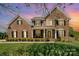 Beautiful brick home with a manicured front lawn, porch, and two-car garage at 2003 Ptarmigan Ct, Waxhaw, NC 28173