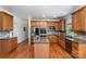 Spacious kitchen featuring stainless appliances, wood cabinets, granite countertops, and wood flooring at 2003 Ptarmigan Ct, Waxhaw, NC 28173