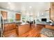 Open-concept kitchen with wood cabinets, granite counters, and breakfast bar, flowing into a dining and living area at 2003 Ptarmigan Ct, Waxhaw, NC 28173