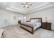 Serene main bedroom featuring neutral tones, tray ceiling, carpet flooring, and ample natural light at 2003 Ptarmigan Ct, Waxhaw, NC 28173