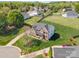 Aerial view of a brick home with large yard and mature trees in a residential area at 2003 Ptarmigan Ct, Waxhaw, NC 28173