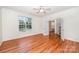 Sunlit bedroom featuring hardwood floors, crown molding and view into hall at 2003 Ptarmigan Ct, Waxhaw, NC 28173