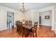 Elegant dining room with dark wood table, chandelier, and hardwood floors at 2003 Ptarmigan Ct, Waxhaw, NC 28173
