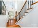 Bright foyer with hardwood floors, staircase, and elegant chandelier at 2003 Ptarmigan Ct, Waxhaw, NC 28173