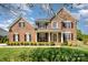 Charming brick home featuring a manicured lawn and beautiful, symmetrical landscaping at 2003 Ptarmigan Ct, Waxhaw, NC 28173