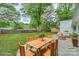 Spacious backyard featuring a patio with outdoor dining set and comfortable lounge seating for relaxing and entertaining at 22025 Torrence Chapel Rd, Cornelius, NC 28031