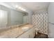 Neutral bathroom with a vanity and large mirror, ample lighting, and shower-tub combination at 22025 Torrence Chapel Rd, Cornelius, NC 28031