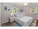 Comfortable bedroom with soft, neutral colors, featuring hardwood floors, recessed lighting, and windows at 22025 Torrence Chapel Rd, Cornelius, NC 28031