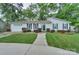 Charming one-story home with well-manicured lawn and walkway, black shutters, and attached garage at 22025 Torrence Chapel Rd, Cornelius, NC 28031