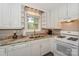 Charming kitchen with white cabinetry, marble countertops, and stainless-steel appliances at 22025 Torrence Chapel Rd, Cornelius, NC 28031