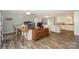 Open-concept living space featuring hardwood floors, a ceiling fan, and a view of the kitchen at 22025 Torrence Chapel Rd, Cornelius, NC 28031