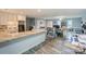 Open floorplan with kitchen space and hardwood floors leading to office and seating area at 22025 Torrence Chapel Rd, Cornelius, NC 28031