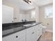 Bathroom with a granite vanity, white cabinets, and natural light at 2518 Glenwood St, Kannapolis, NC 28083