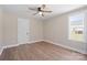 Bedroom features a ceiling fan, wood-look flooring, and a window with a view at 2518 Glenwood St, Kannapolis, NC 28083