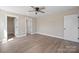 Spare bedroom offers wood floors, neutral paint, ceiling fan and closet at 2518 Glenwood St, Kannapolis, NC 28083