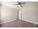 Neutral bedroom featuring hardwood floors, ceiling fan, and white trim at 2518 Glenwood St, Kannapolis, NC 28083