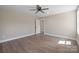 Cozy bedroom with neutral paint, ceiling fan, and wood flooring at 2518 Glenwood St, Kannapolis, NC 28083